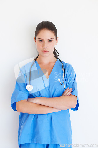Image of Portrait, woman and doctor with arms crossed standing isolated against a white studio background. Confident female medical professional, expert or nurse with stethoscope for healthcare or profile