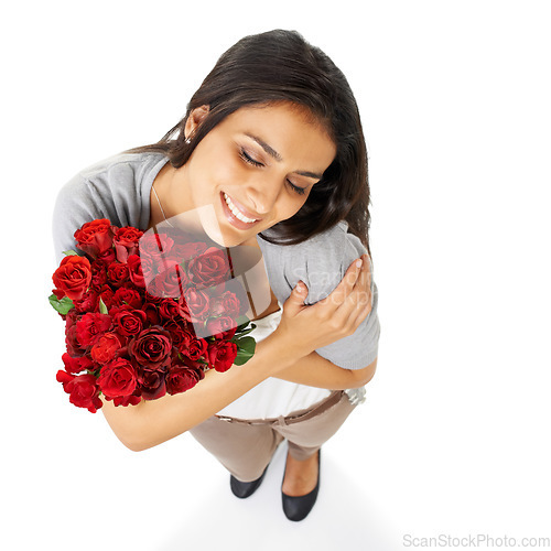 Image of Above, hug and woman with rose in studio for love, romance and valentines day against a white background space. Happy, smile and bouquet for indian girl embrace floral, gesture and romantic isolated