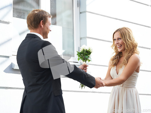 Image of Man, flowers and woman with smile for valentines day, relationship or celebration for date. Happy couple holding hands with white roses or bouquet to celebrate anniversary or special month of love