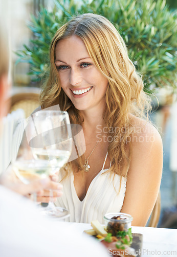 Image of Woman, couple and champagne toast at a restaurant for valentines day, love and celebration. Wine, toasting and cheers from lady to man on first date, birthday or romance, anniversary and celebrating