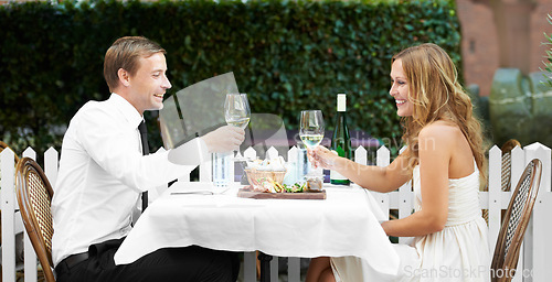 Image of Love, couple and toast at restaurant, celebration and happy for relationship, anniversary and dating. Romance, man and woman cheers with champagne, romantic and loving together, bonding and happiness