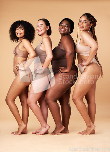 Image of Diversity women, skin and body positivity portrait of friends together for inclusion, beauty and power. Underwear model group on beige background with cellulite, pride and motivation for self love