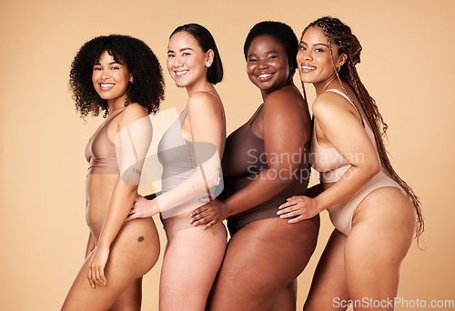 Image of Diversity women, body shape and portrait of group together for inclusion, natural beauty and power. Underwear model friends happy on beige background with cellulite, pride and self love motivation