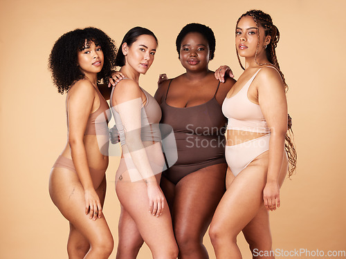 Image of Body, skin and diversity women portrait of group together for inclusion, beauty and power. Underwear model friends hug on beige background with skincare, color pride and motivation for self love