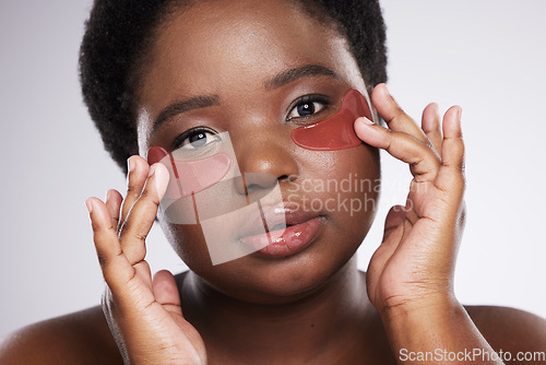 Image of Black woman, face and portrait with eye patch for skincare, healthy skin and glow isolated on studio background. Hands, shine and natural cosmetics, dermatology and facial mask with beauty care
