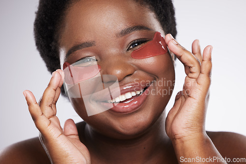 Image of Black woman, face and happy with eye patch for skincare, healthy skin and portrait isolated on studio background. Hands, shine and natural cosmetics, dermatology and facial care with beauty mask