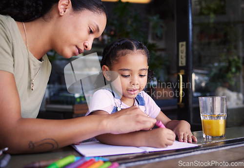 Image of Coffee shop, black family and art with a woman and daughter using crayons to color a book in a cafe together. Juice, coloring and creative with a mother and happy female child bonding in a restaurant