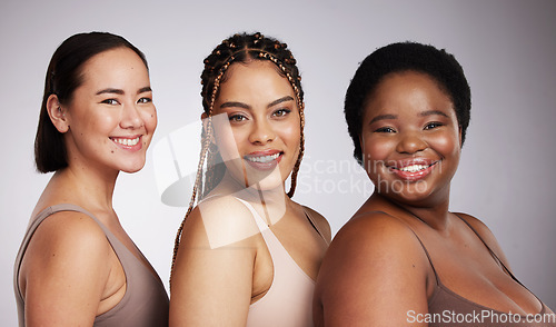 Image of Portrait, skin and diversity with woman friends in studio on a gray background together for skincare beauty. Face, makeup and natural with a female model group posing to promote support or inclusion