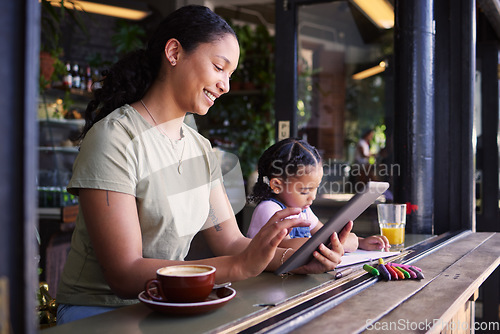 Image of Black family, children and mother remote working at a cafe together with her daughter coloring in a book. Tablet, internet or coffee shop with a woman freelancer and her female child at a restaurant