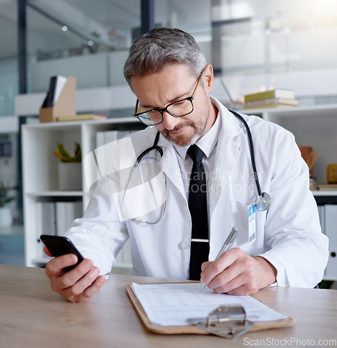 Image of Man, writing on checklist and doctor with phone in hospital for healthcare, information or research. Telehealth technology, medical smartphone and mature physician with mobile, clipboard or documents