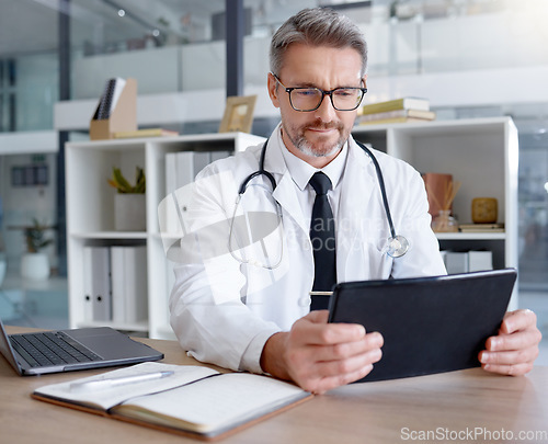 Image of Medical doctor, tablet and man in hospital for telehealth, online consultation and healthcare. Clinic technology, wellness app and mature male physician with digital touchscreen for health research.