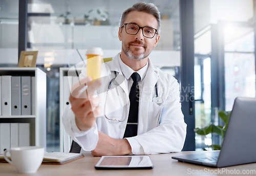 Image of Medical doctor, portrait and pills in hospital for healthcare, wellness and health in clinic. Medicine, medication and male physician holding medicinal drug product or prescription for healthy cure.