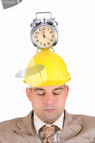 Image of sleepy businessman with clock alarm 