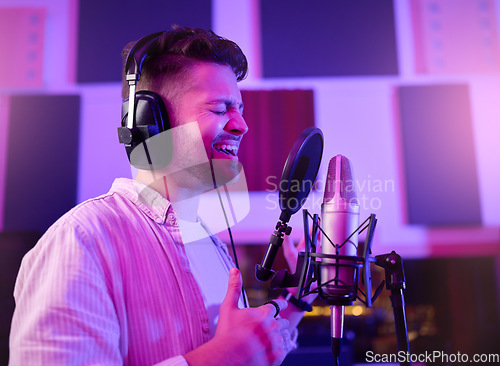 Image of Musician, singer or man on neon microphone, karaoke studio or theatre practice in night booth recording. Singing, person or pop artist on production, voice media or sound performance in light theater