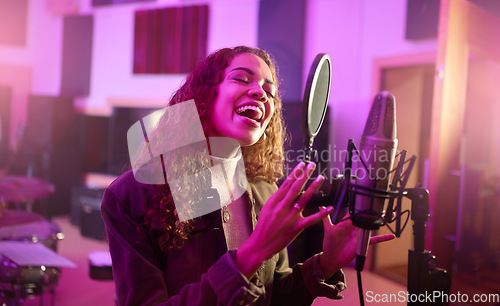 Image of Musician, singing or woman on neon studio microphone, music equipment or practice in night theatre recording. Singer, person or artist on production, voice media or sound performance in light theater