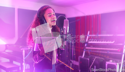 Image of Technology, singing or woman on neon studio microphone, music lyrics or songwriting app in night recording. Singer, musician or artist on tablet in production, voice media or sound light performance