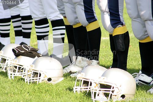 Image of referee and football players