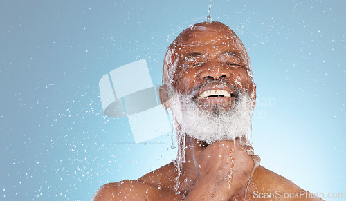 Image of Water, splash and mockup with black man and shower for skincare, hygiene and dermatology. Wellness, spa and facial with senior model cleaning in blue background studio for health, luxury or hydration