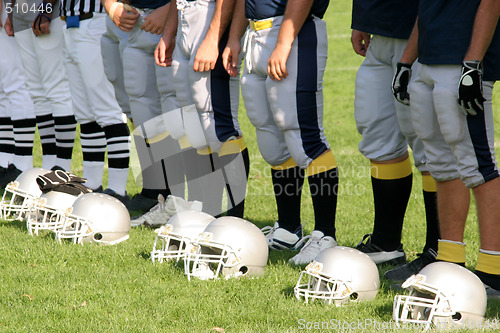 Image of referee and football players