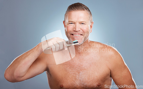 Image of Smile, portrait or old man brushing teeth with dental toothpaste for healthy oral hygiene grooming in studio. Eco friendly, happy or senior person cleaning mouth with a natural bamboo toothbrush