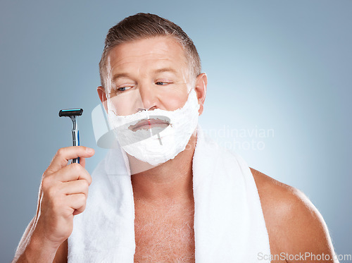 Image of Skincare, razor and old man shaving in studio with foam, beauty or grooming on grey background. Face, doubt and mature male model relax for luxury, hair removal and facial, skin and product isolated