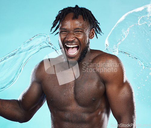 Image of Water splash, black man and body with shower, happiness and surprise with skincare isolated on blue background..Excited, clean skin and natural cosmetics with grooming, hygiene and beauty in studio