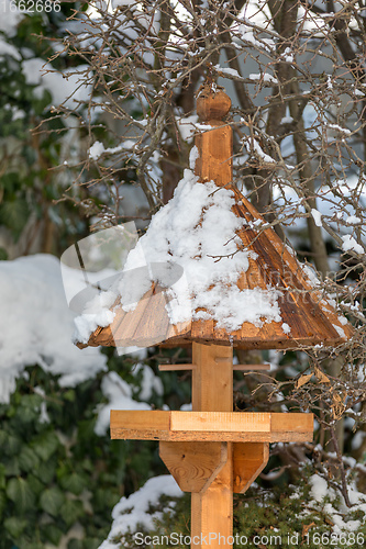 Image of simple birdhouse in winter garden