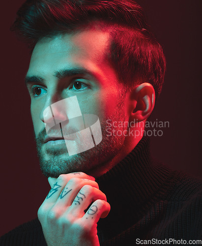 Image of Idea, fashion and red with a handsome man model in studio on a dark background for contemporary beauty. Face, thinking and art with a young male posing indoor to promote trendy clothes or style