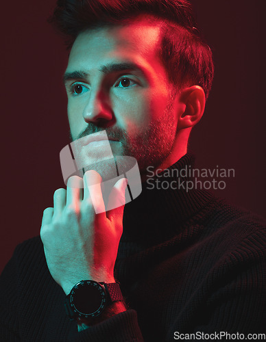 Image of Idea, beauty and red with a handsome man model in studio on a dark background for contemporary fashion. Face, thinking and art with a young male posing indoor to promote trendy clothes or style