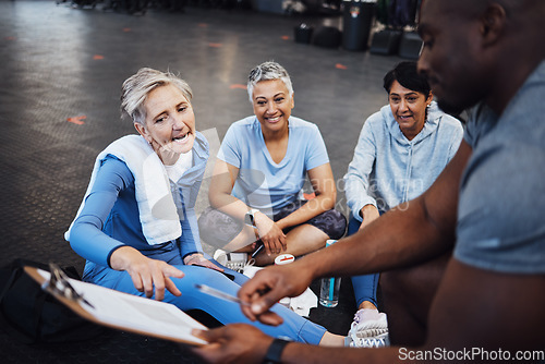 Image of Senior woman, talking and personal trainer contract with elderly friends ready for wellness. Sports checklist, gym document and workout group with happiness in a training gym floor for fitness