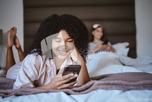 Image of Contact, phone and smile with black woman at sleepover for communication, internet or online dating. Happy, relax and texting with girl and friends in bedroom with technology, digital or social media