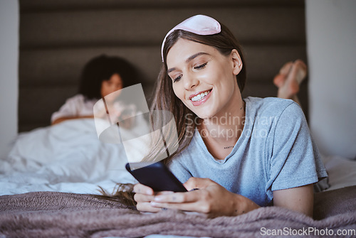 Image of Phone, bedroom and woman sleepover with social media, networking and internet search for blog tips. Relax, holiday and happy person or youth on bed typing on mobile chat app, cellphone or smartphone