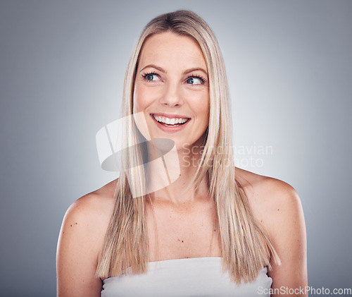 Image of Woman, thinking and hair care aesthetic with mockup in a studio for wellness and beauty. Facial, smile and happy model with gray background and mock up ready for dermatology and spa treatment