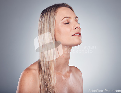 Image of Skincare, haircut and beauty hair salon by woman or blonde due to care or cosmetic shampoo isolated in studio grey background. Treatment, balayage and girl with healthy shine and glow due to keratin