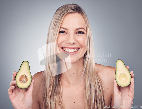 Image of Beauty, skin or hair care avocado for woman portrait in studio with natural cosmetic and shampoo shine. Face of aesthetic model with fruit on grey background for hairdresser or sustainable product