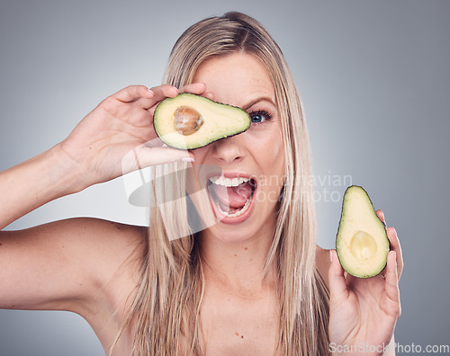 Image of Beauty, avocado and skin care woman portrait in studio with natural glow and cosmetic shine. Comic face of aesthetic model excited on grey background for sustainable food or hair product benefits