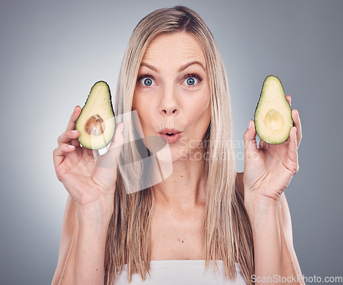 Image of Avocado, beauty and skin or hair care woman portrait in studio with natural cosmetic and shampoo shine. Face of aesthetic model excited on grey background for hairdresser or wow sustainable product