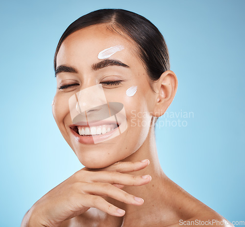 Image of Beauty cream, skin and face of a happy woman with hand for dermatology, cosmetics and natural glow. Aesthetic model person with natural spa facial self care for health and wellness on blue background