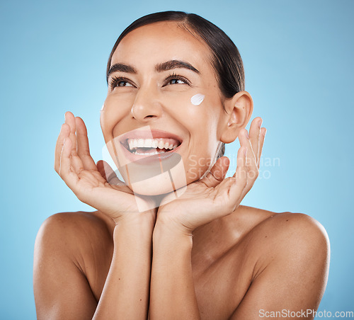Image of Beauty cream, skincare and happy face of a woman with hands for dermatology, cosmetics and glow. Aesthetic model with spa natural facial self care for health and wellness on a blue background