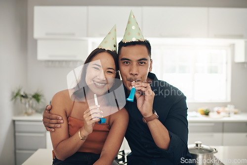 Image of Happy, birthday celebration and portrait of a couple with party hats in a kitchen. Love, care and Asian woman with a man together in a home with happiness to celebrate holiday in a house on date