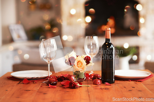 Image of Romantic, dinner table and setup for valentines day, fine dining or date at indoor night restaurant. Interior diner with wine glasses prepared with roses and champagne for evening couple reservation