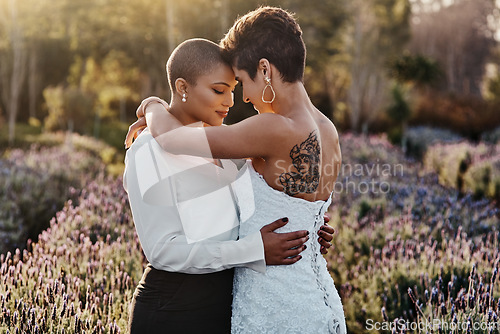 Image of Married couple, lesbian and hug in embrace for LGBT, gay or transgender relationship in the nature outdoors. Happy women hugging for wedding, marriage or commitment in support for sexuality together