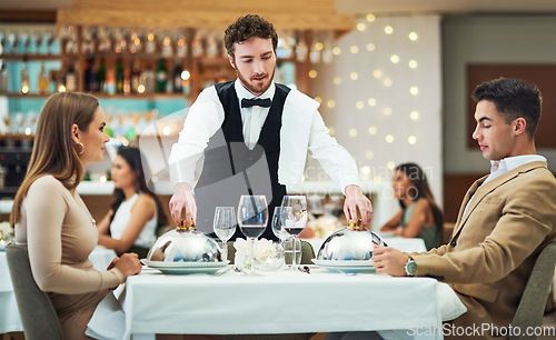 Image of Restaurant, food and valentines day with a couple at a table in celebration of love, romance or marriage together. Wine, night or luxury fine dining with a man and woman celebrating their anniversary