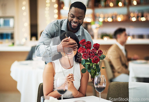 Image of Rose surprise, couple and restaurant of people ready for fine dining with love and care. Flowers present, bouquet and date of a woman and man together with celebration on a table with a smile