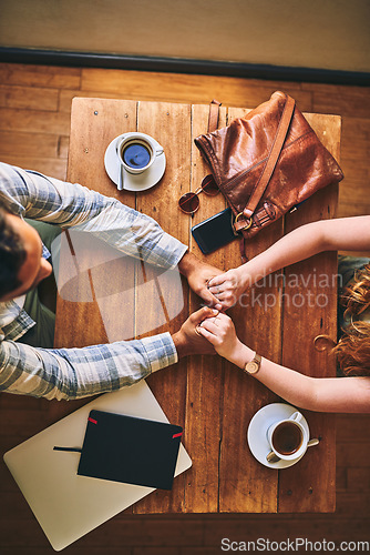 Image of Top view, couple and coffee shop with holding hands, love and conversation for romance at table. Man, woman and valentines date in cafe for support, bonding and talking with happiness, care and trust