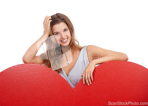 Image of Happy, smile and woman with a heart in a studio for valentines day, anniversary or romance. Happiness, excited and portrait of a female model with a love shape or gesture isolated by white background