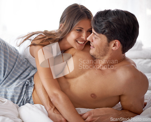 Image of Love, couple in bedroom and affection with smile, romance and partners bonding, break and relationship. Romantic, man and woman intimate connection in bed, happy or loving together, cuddle or embrace