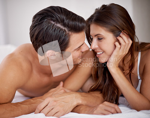 Image of Intimate, romantic and couple in the bedroom for conversation, relaxing and honeymoon in a hotel. Love, happy and young man and woman lying on a bed after valentines day, anniversary or a date