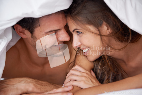 Image of Love, happy and couple in bed, waking up and bonding in a bedroom together, flirting and romantic. Romance, man and woman relax, intimate and resting at hotel for valentines day, anniversary or bond