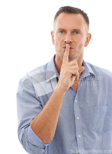 Image of Secret, quiet and portrait of a man in a studio with a silence, hush or whisper face expression. Person, handsome and mature male model with a finger on his mouth gesture isolated by white background